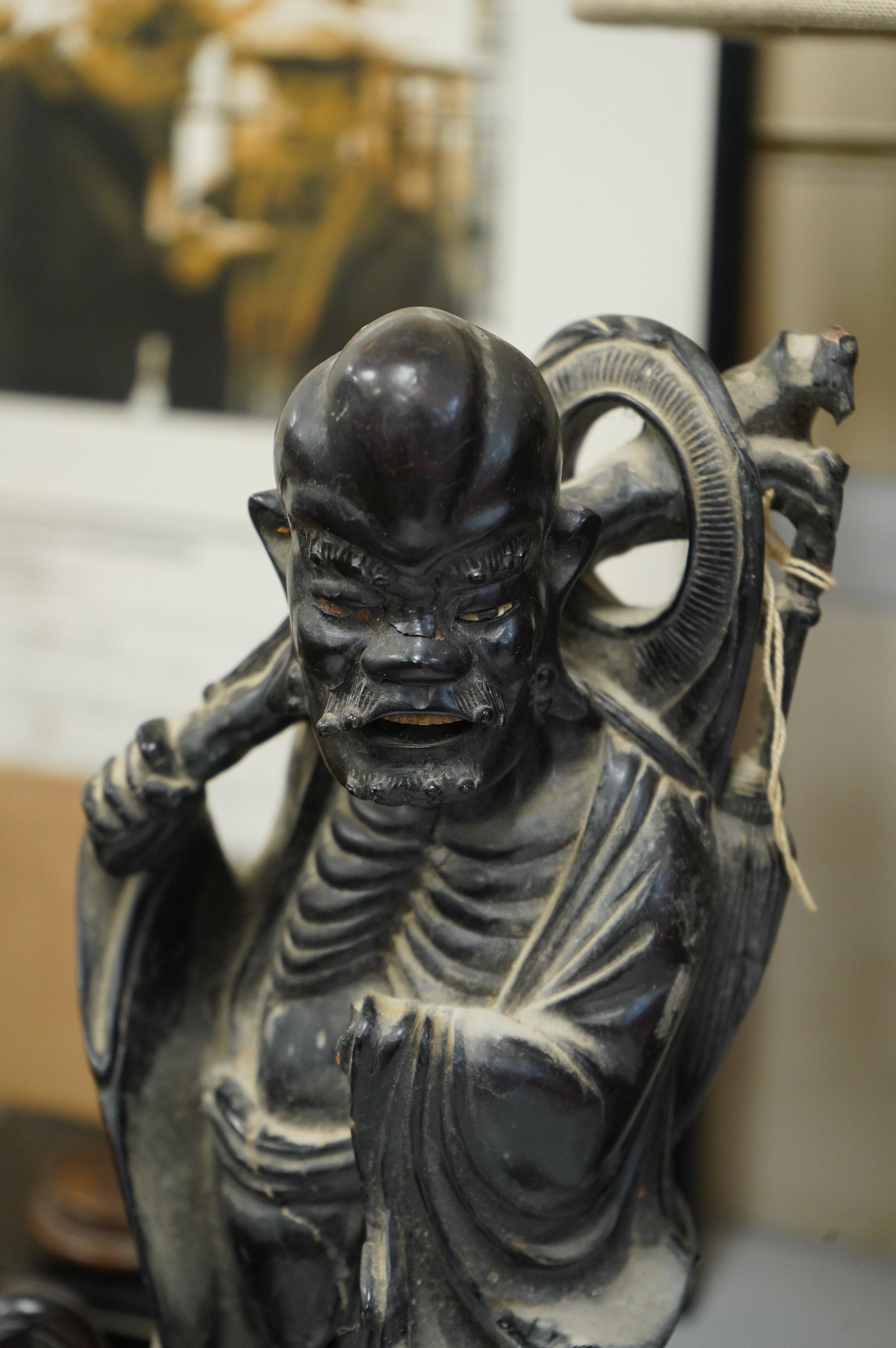 A collection of various Chinese stands, a carving of an ox and another